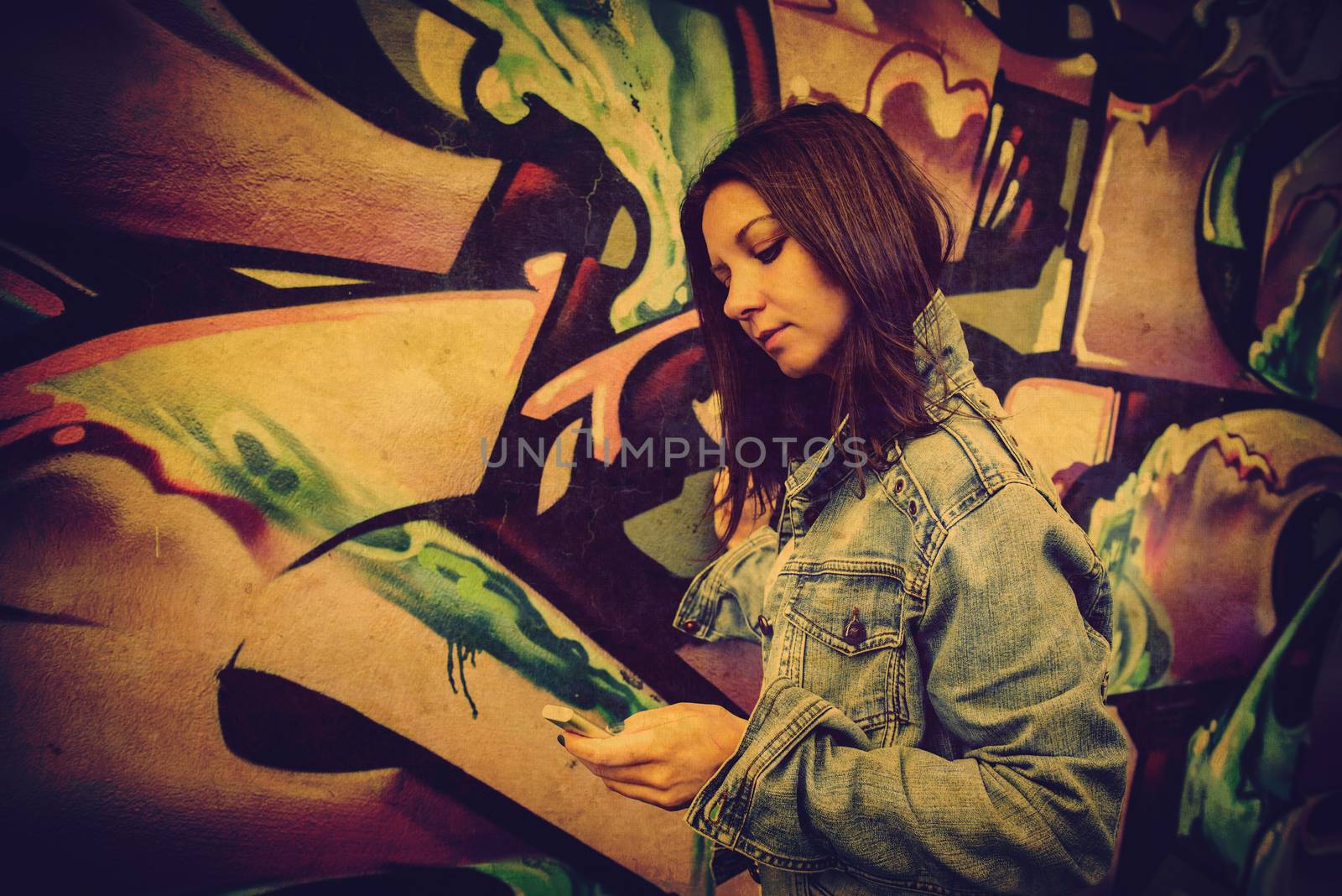 girl in sunglasses near graffiti wall