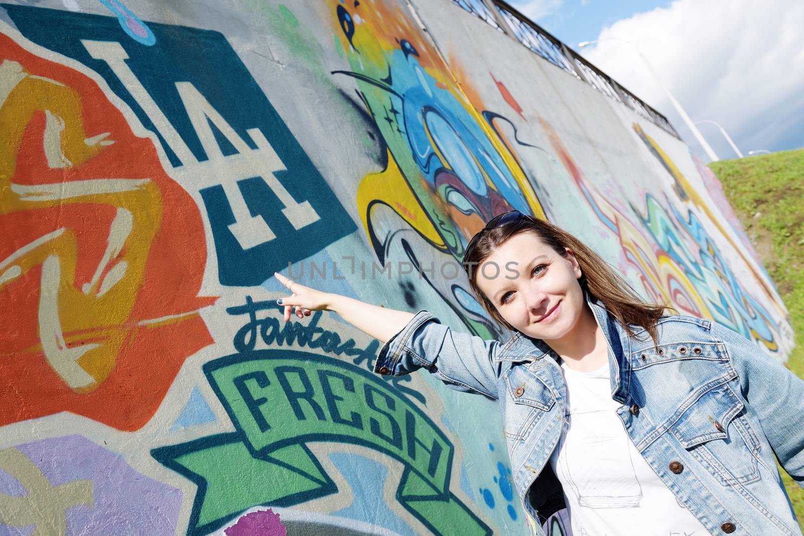 girl in sunglasses near graffiti wall by shesaysboo