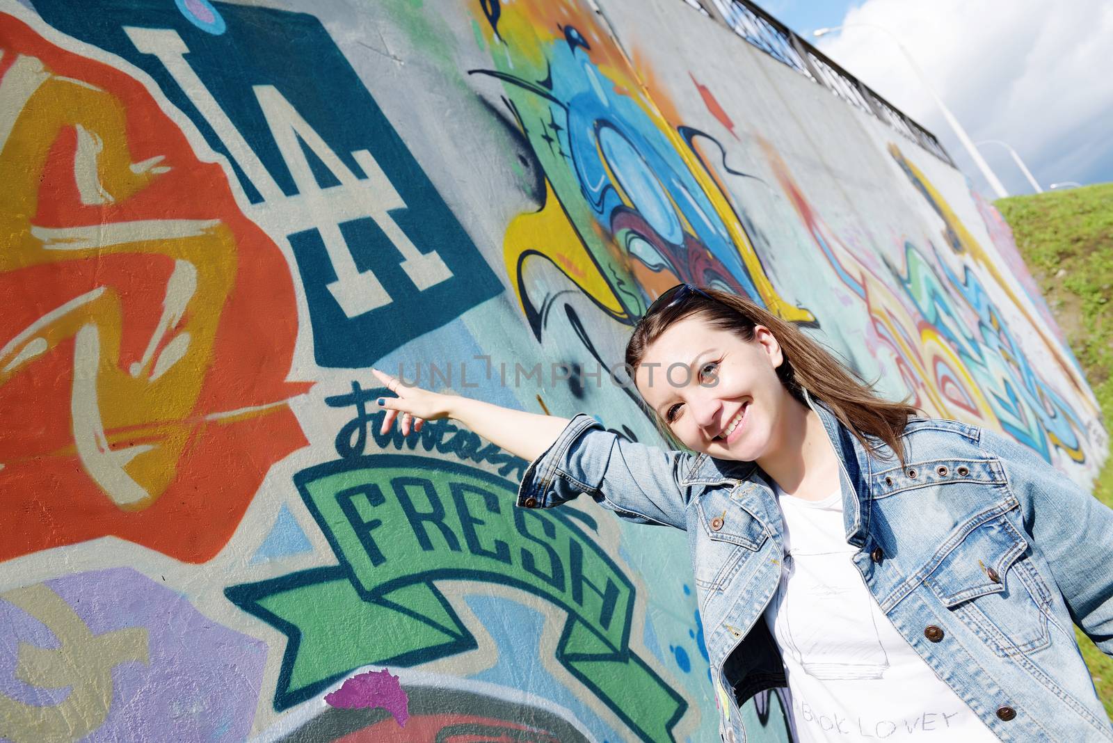 girl in sunglasses near graffiti wall by shesaysboo