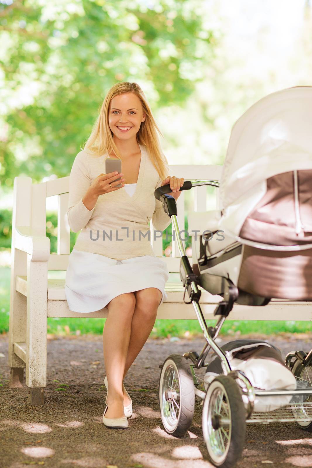 family, parenthood, technology and people concept - happy mother with with smartphone and baby stroller in park