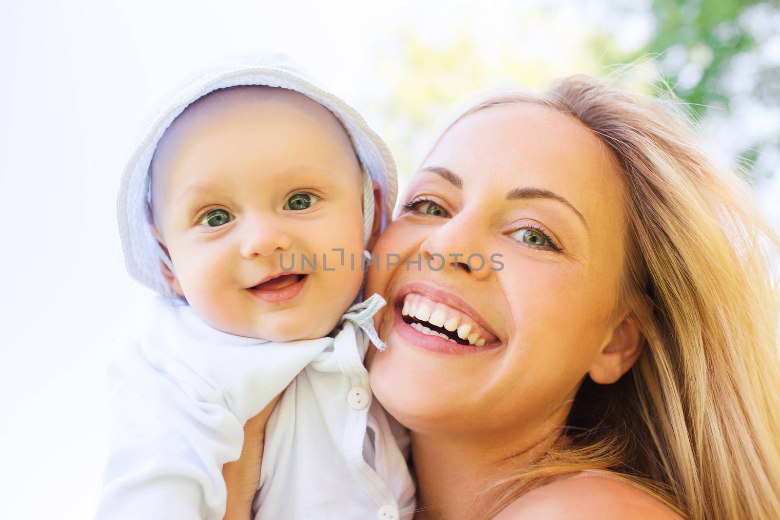 family, child and parenthood concept - happy mother with little baby outdoors