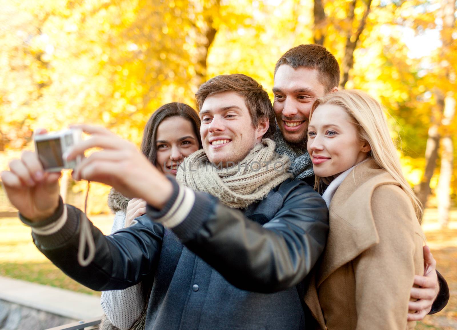 group of smiling men and women making selfie by dolgachov