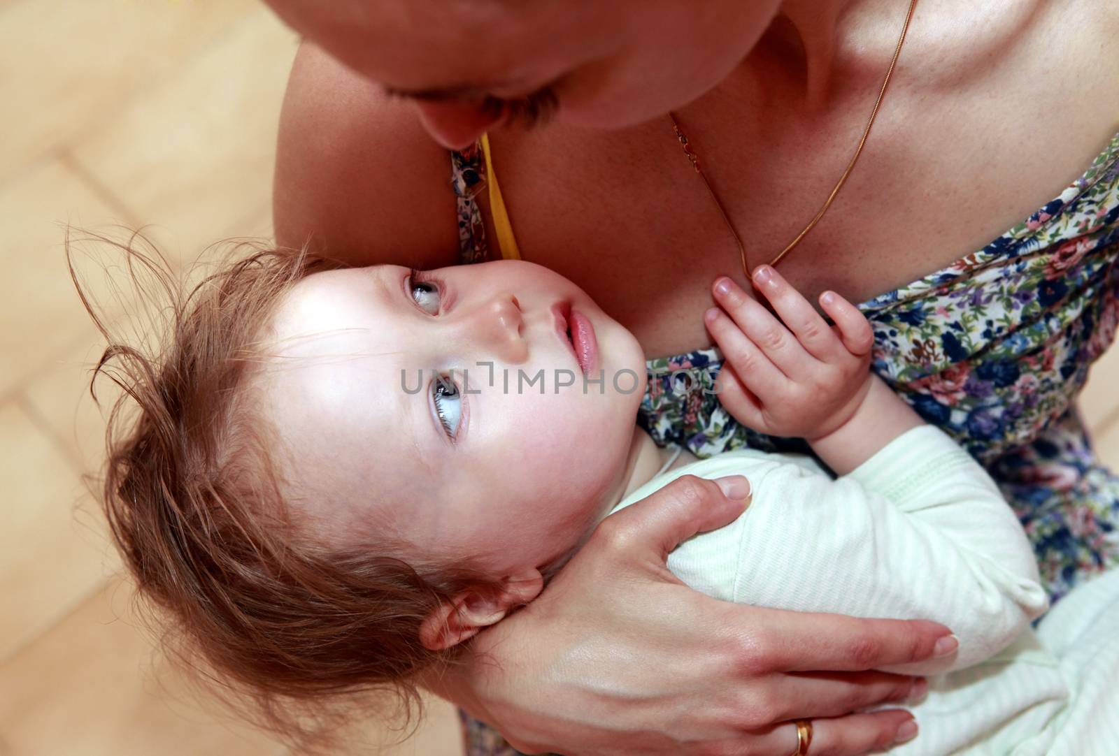 Mother calms his baby daughter at home