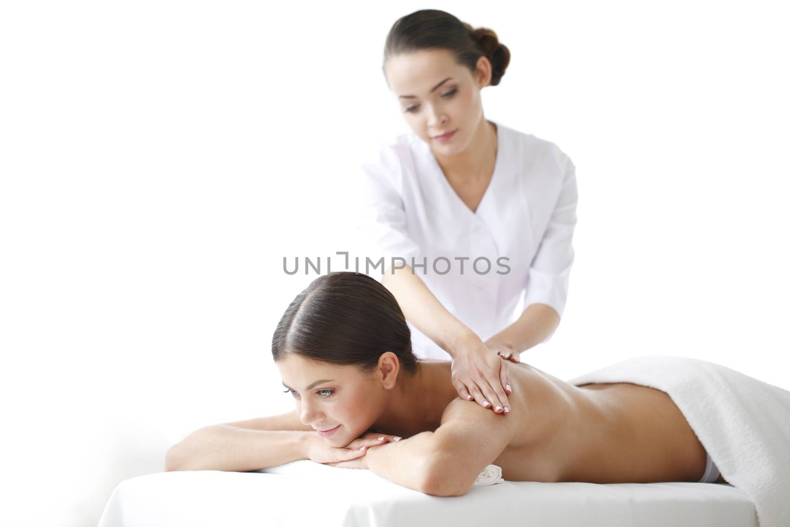 Beautiful young woman getting massage, isolated on white background