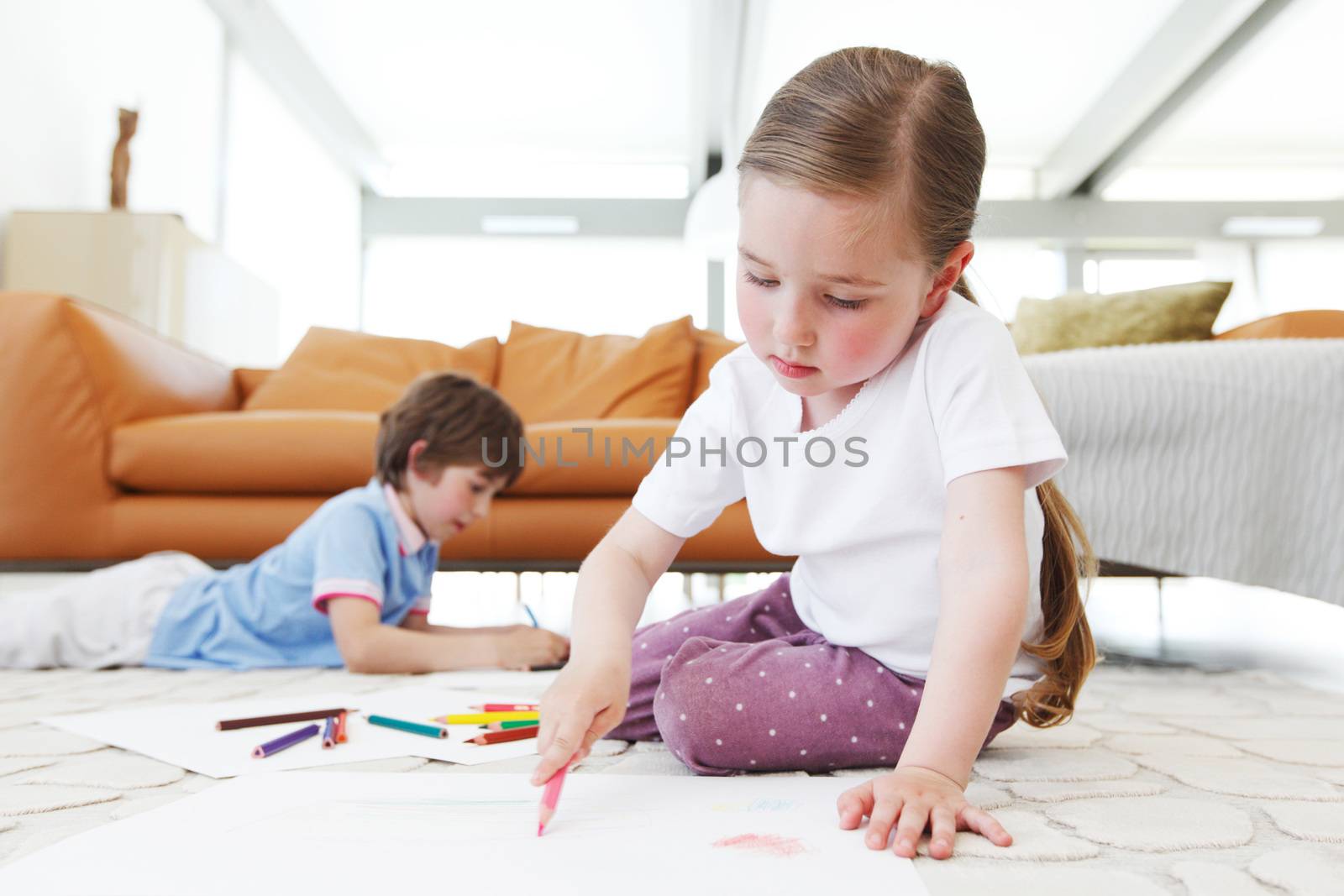 brother and sister drawing pictures with coloring pencils