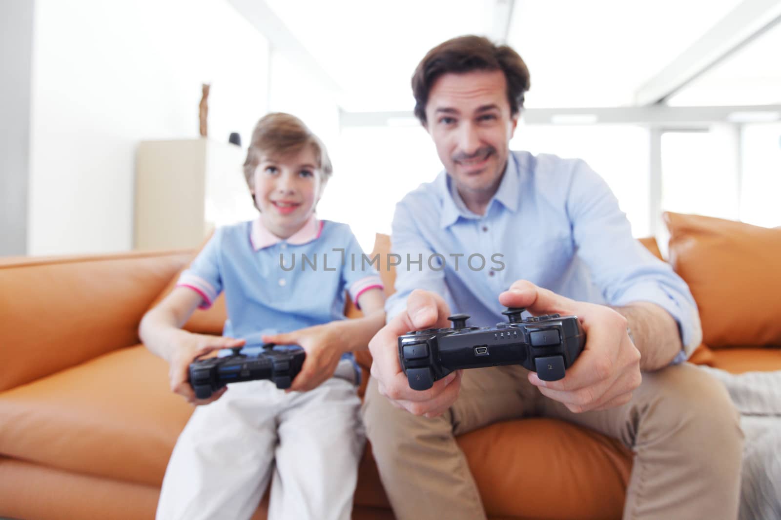 father and son play video game inside their house