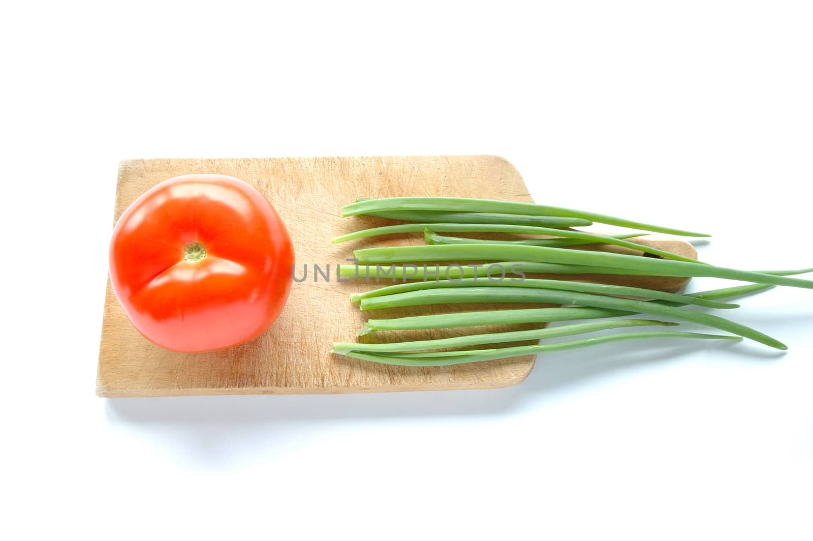 Vegetables on chopping board on white background