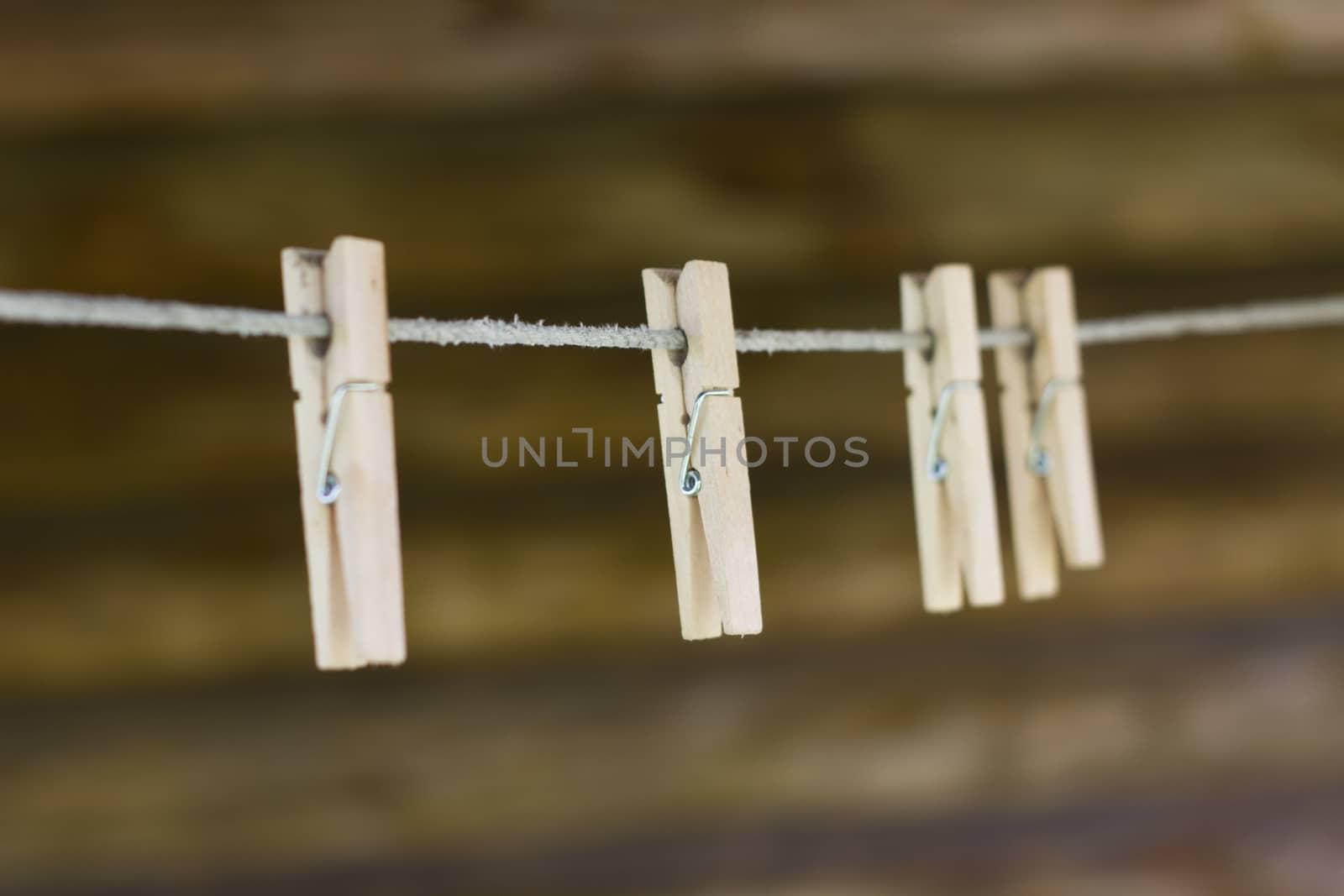 Wooden clothespins on the clothesline by olegkozyrev