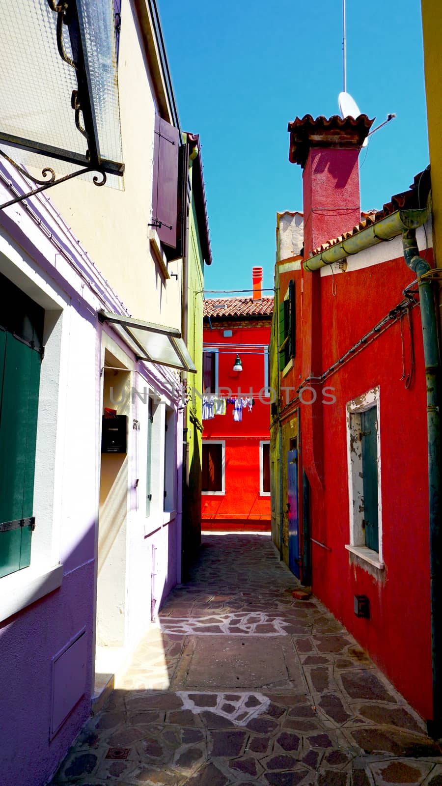 allley in Burano with colorful building architecture, Venice, Italy