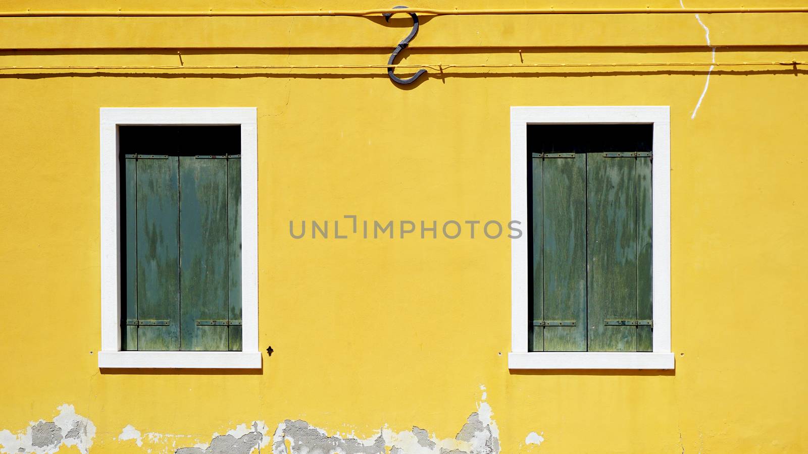 green woodem Window on yellow wall  by polarbearstudio