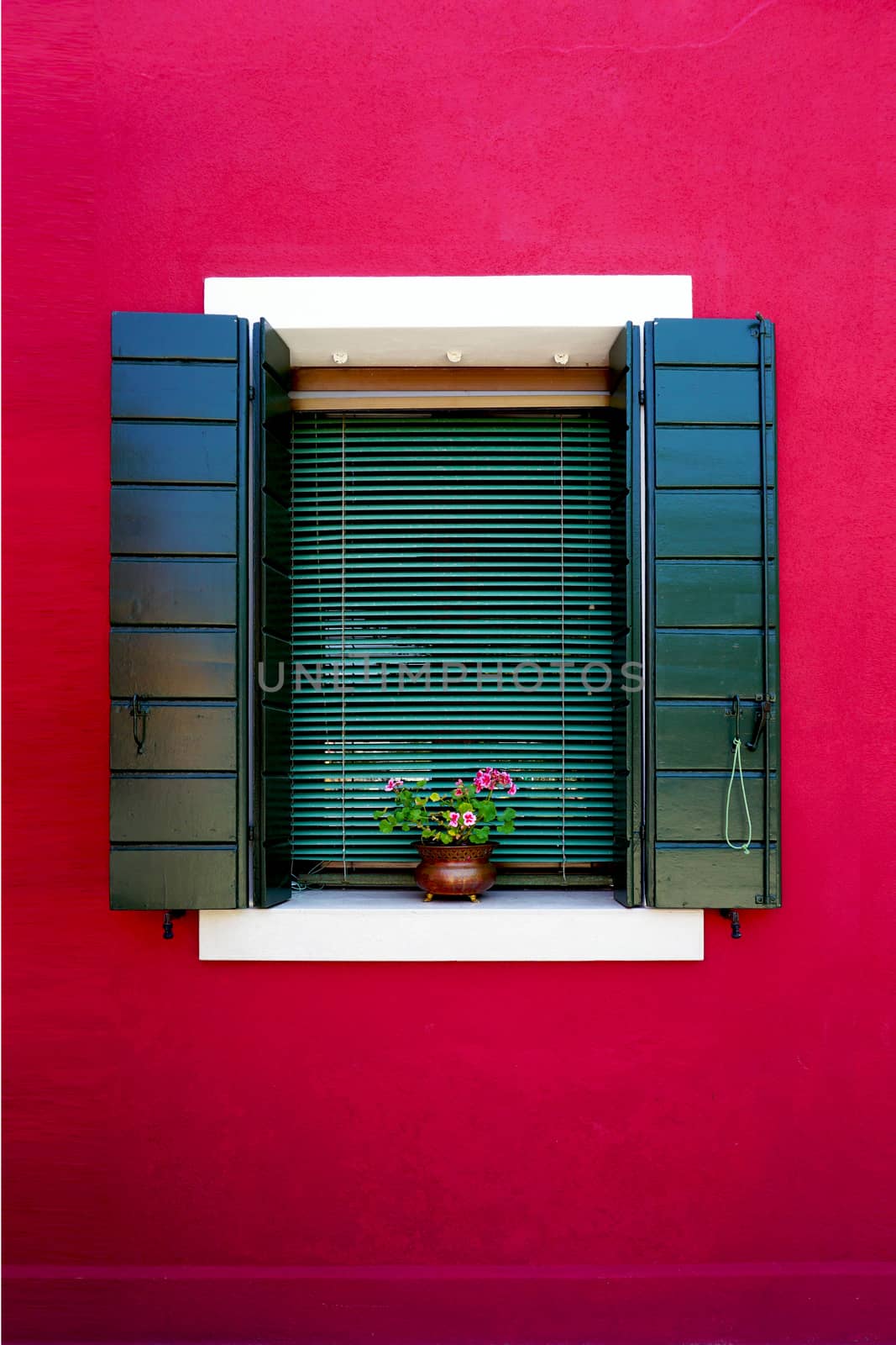 Window in Burano colorful wall building architecture, Venice, Italy