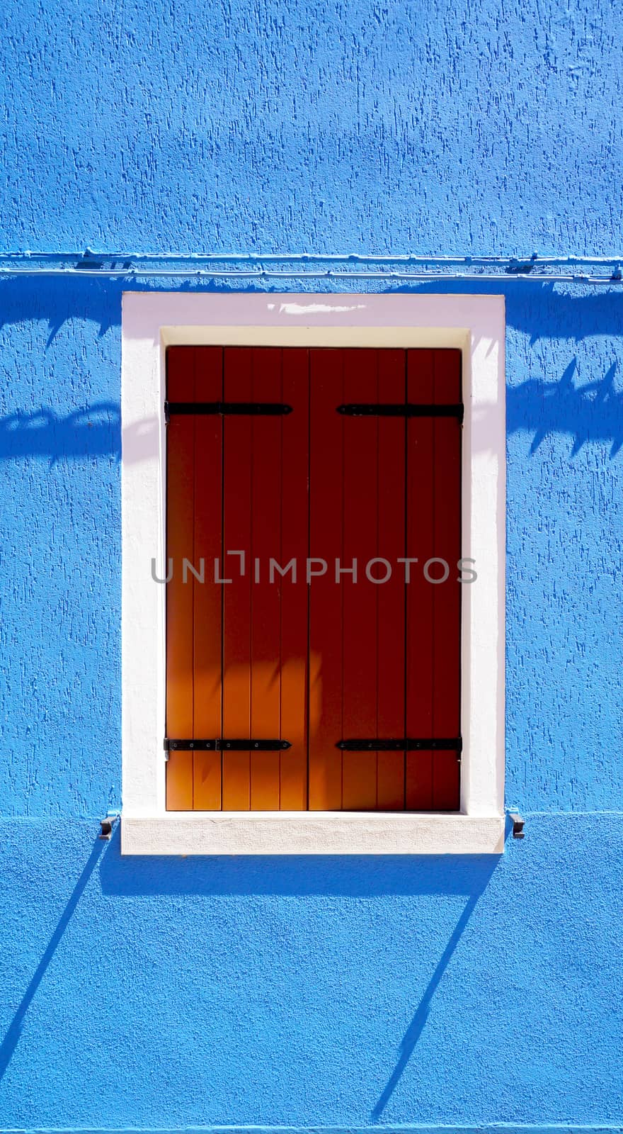 Wooden Window in Burano on blue color wall  by polarbearstudio