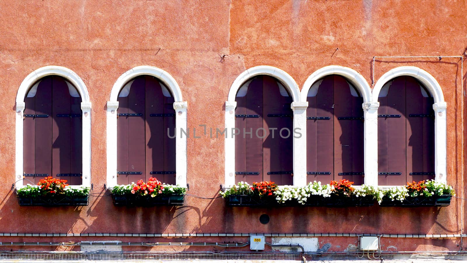 five wooden windows and ancient decay wall building architecture in Murano, Venice, Italy        