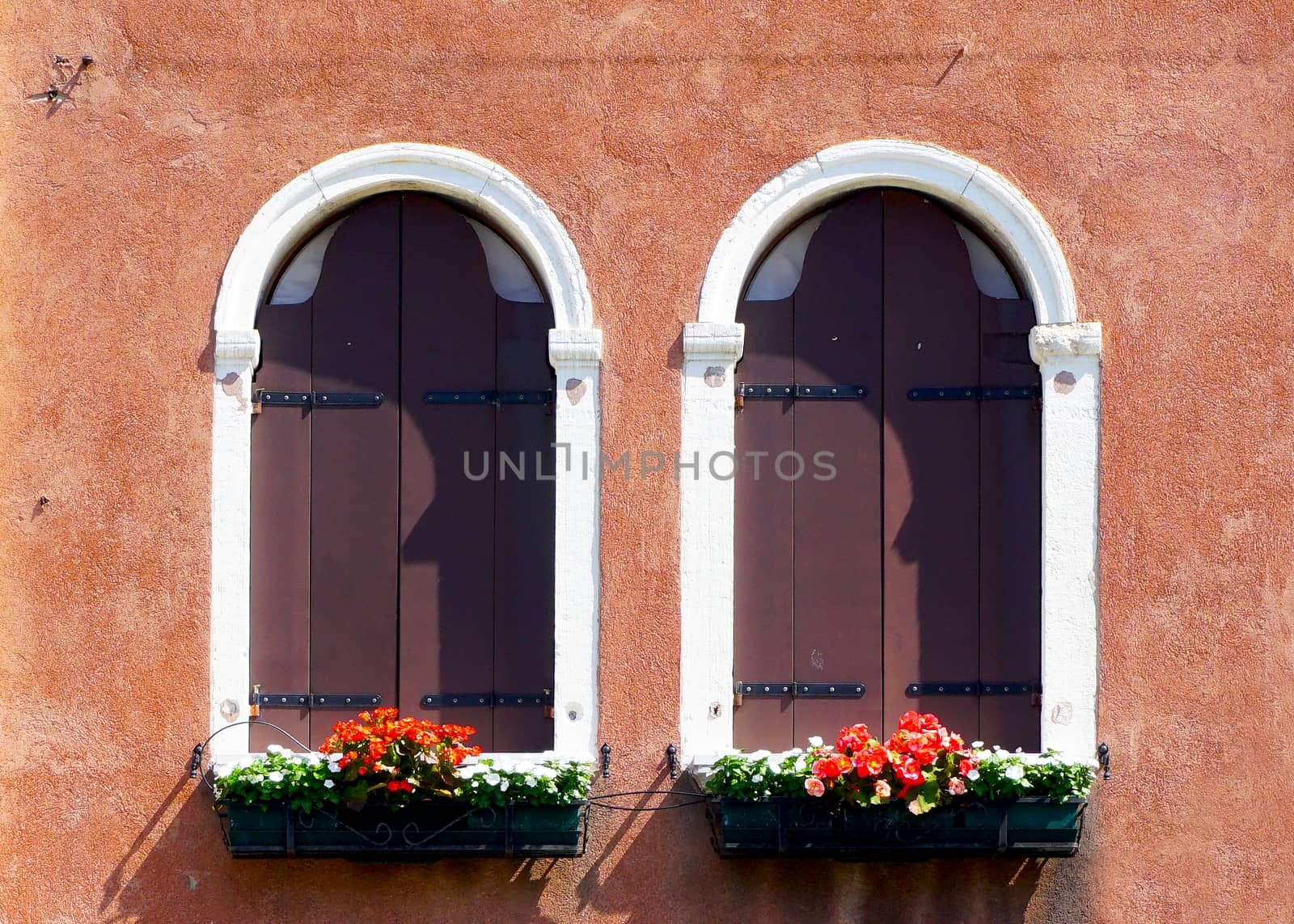 two arch window and ancient decay orange wall building architecture in Murano, Venice, Italy