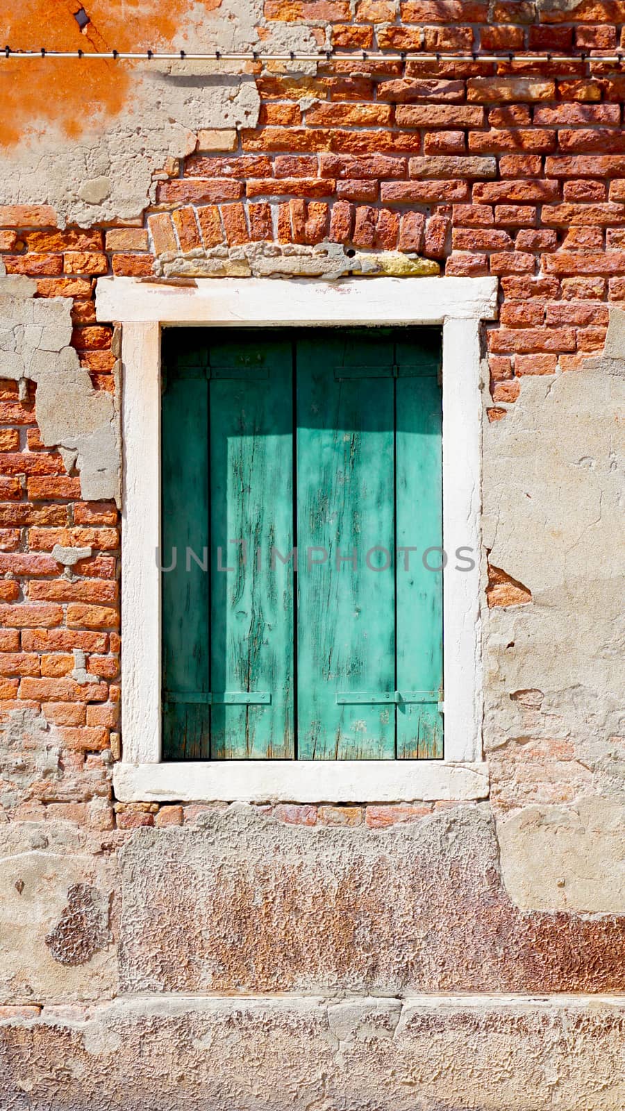 window and ancient decay wall building architecture in Murano, Venice, Italy