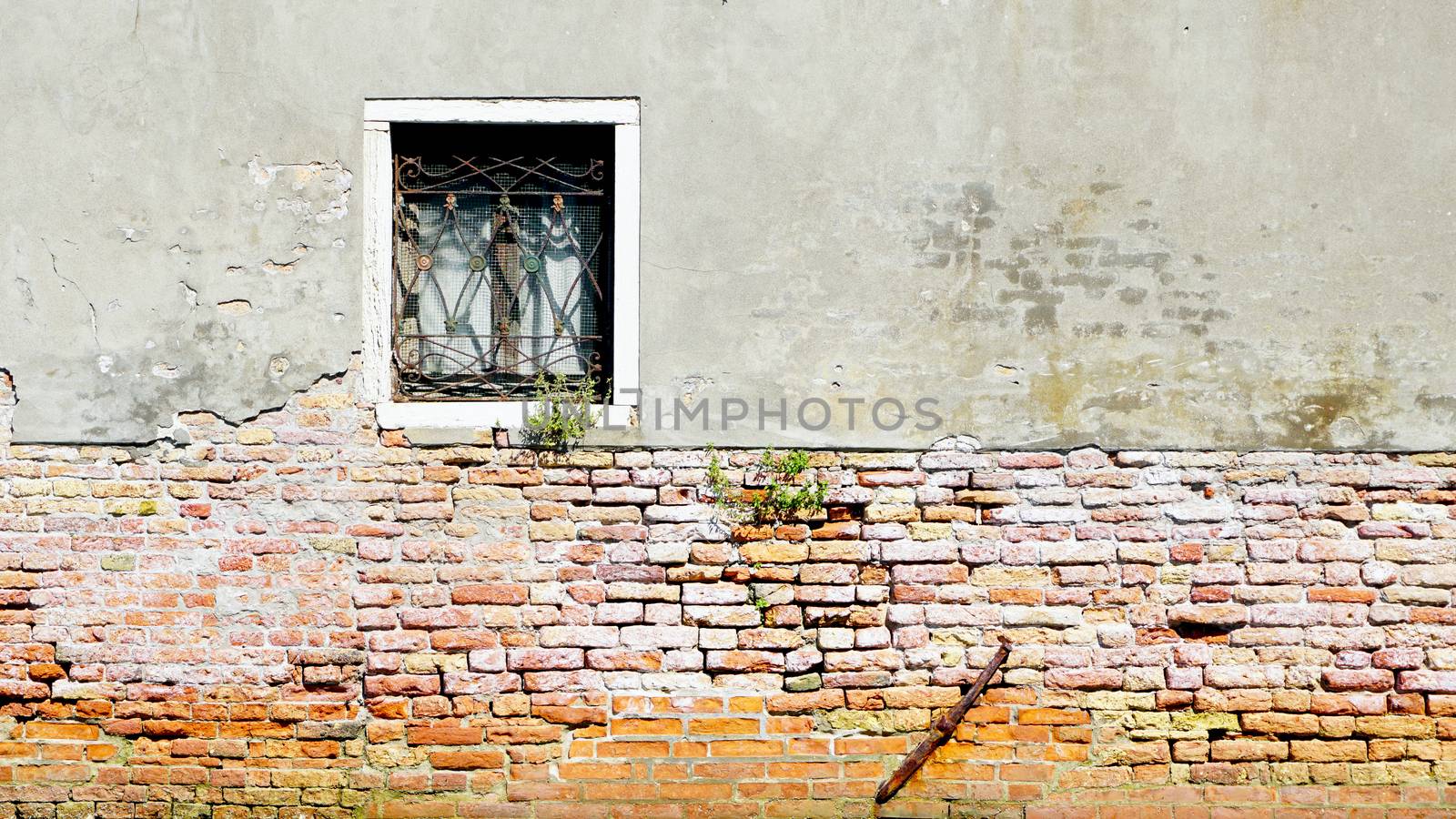 window and ancient decay wall half brick wall building architecture in Murano, Venice, Italy