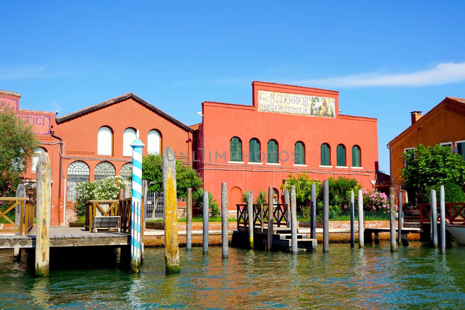 building architecture, pier and boats in Murano, Venice, Italy