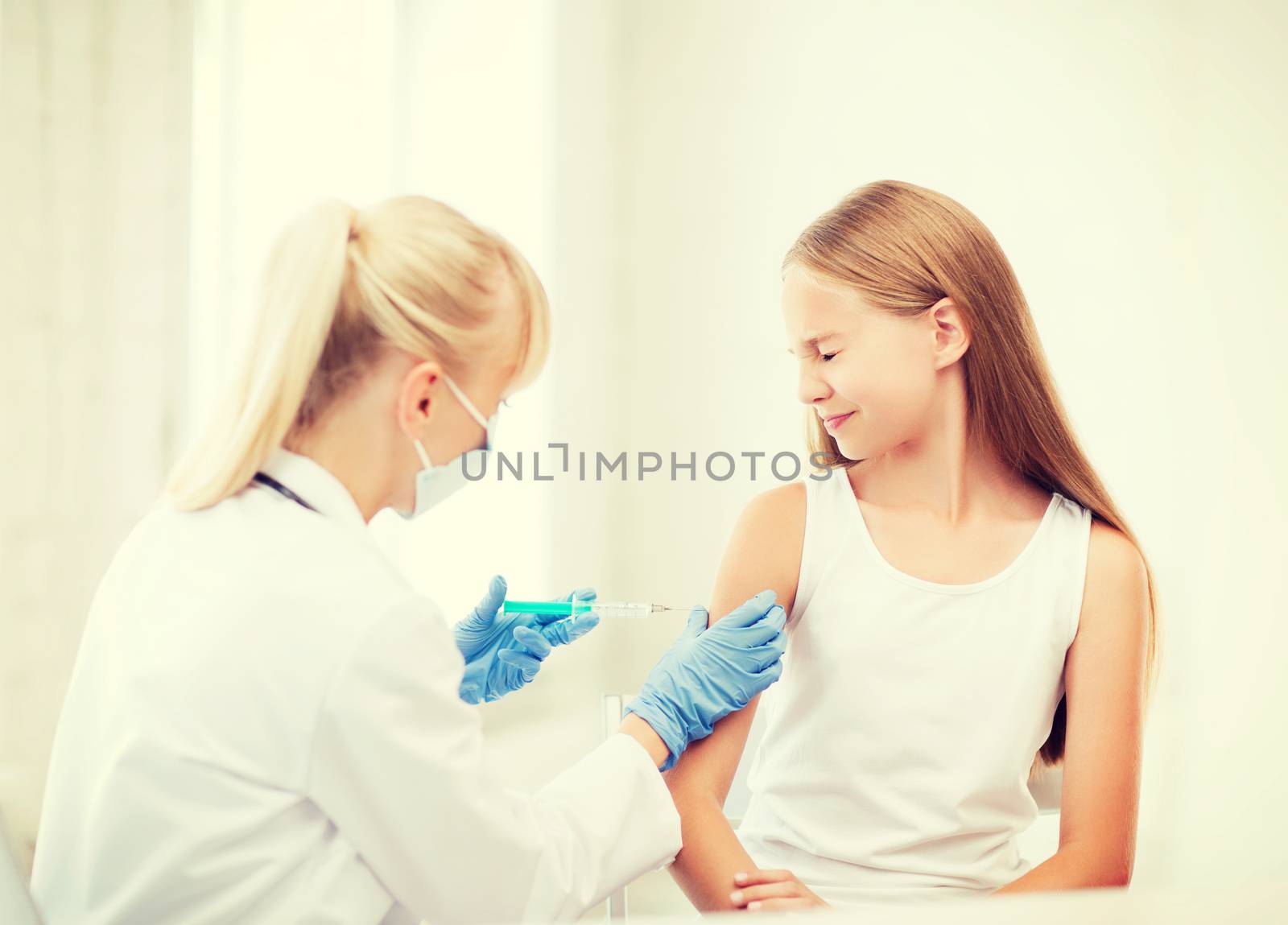 healthcare and medical concept - doctor doing vaccine to child in hospital