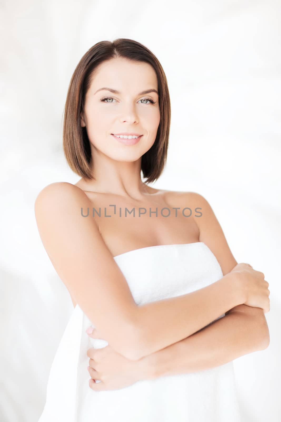 beauty, spa and people concept - beautiful woman standing in towel