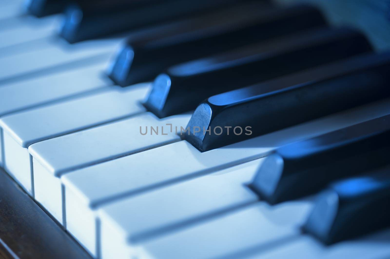 Close-up of piano keys in blues as a concept for jazz