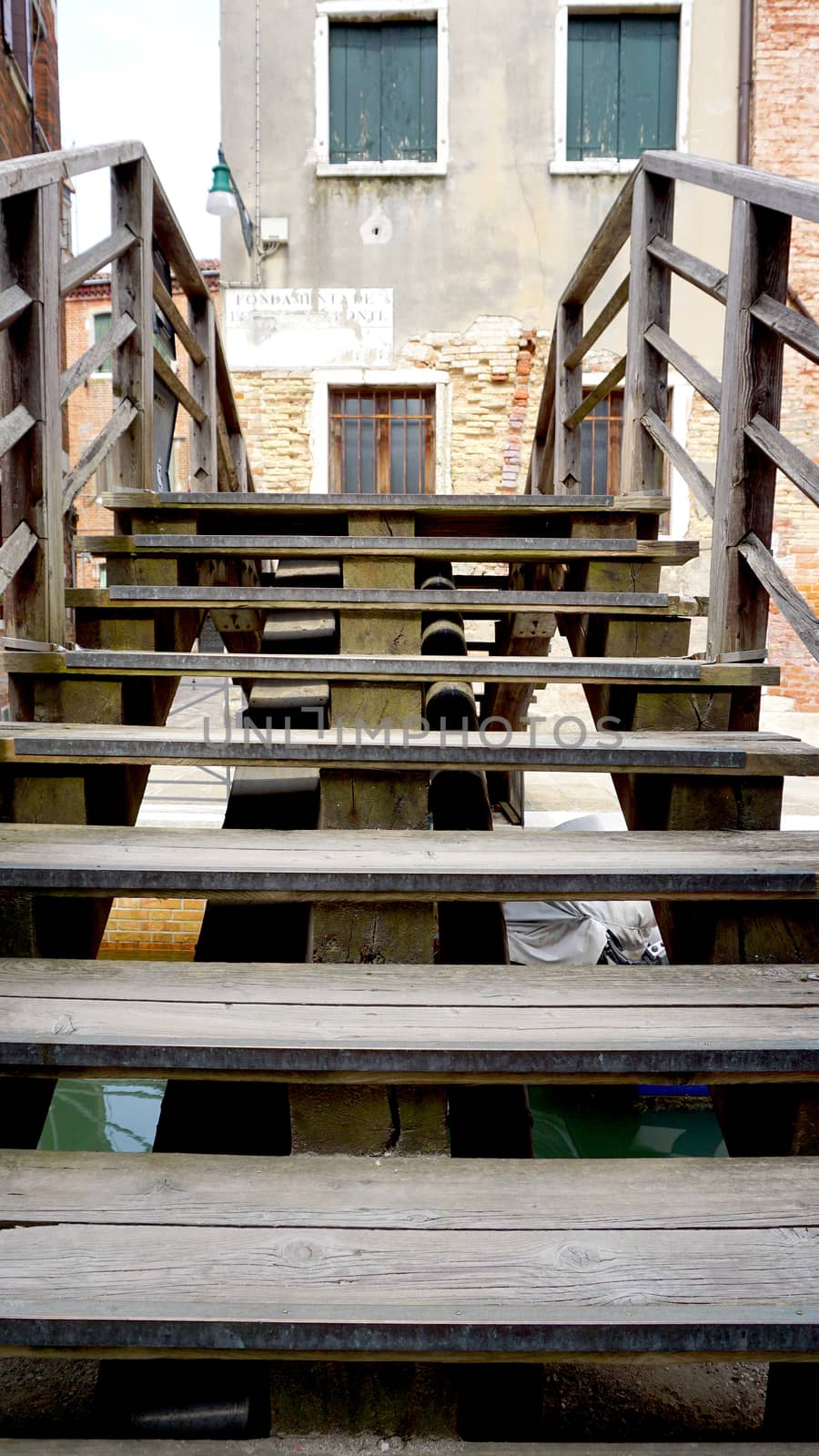 wooden stair bridge cross canal Venice, italy