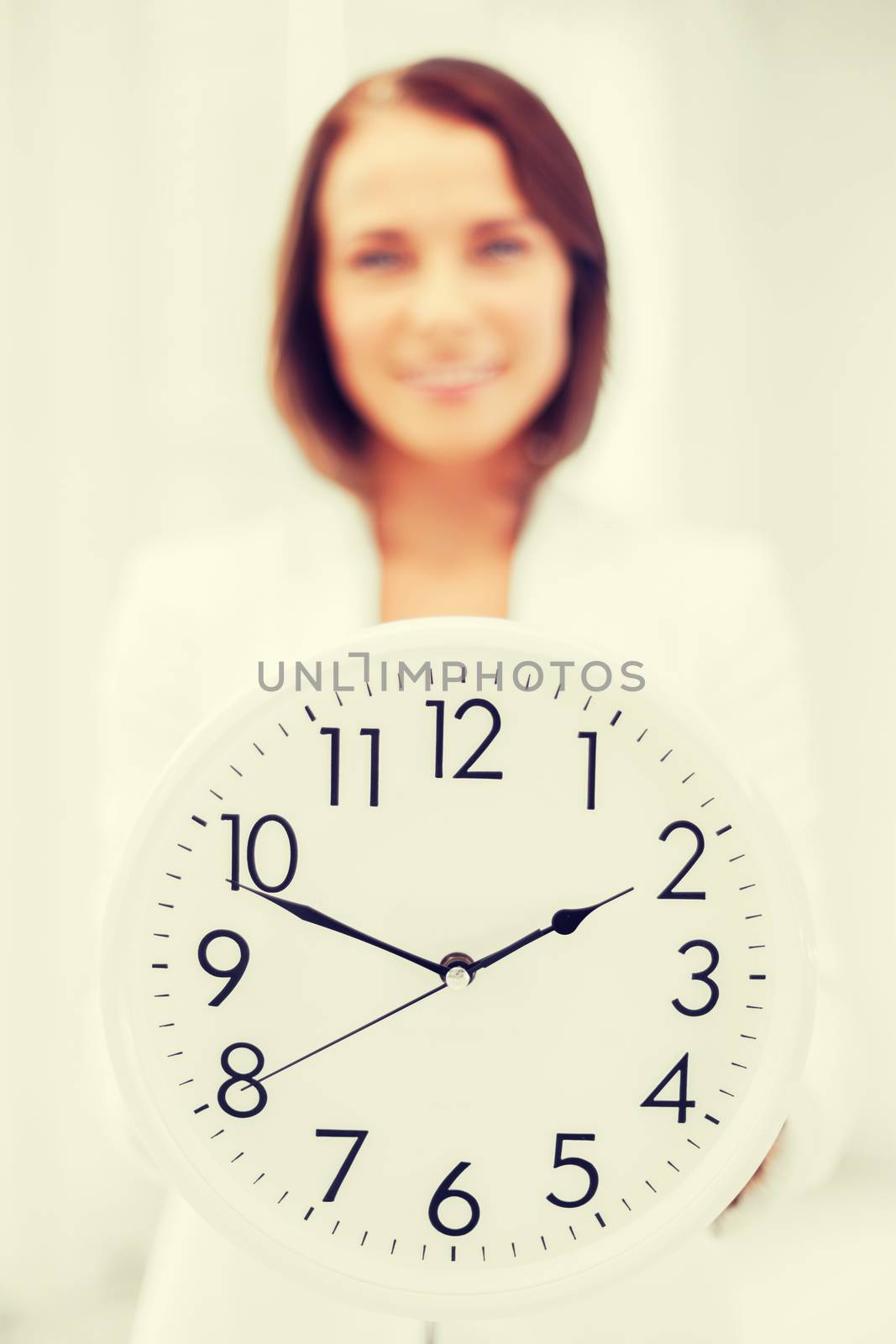 attractive businesswoman with white clock by dolgachov