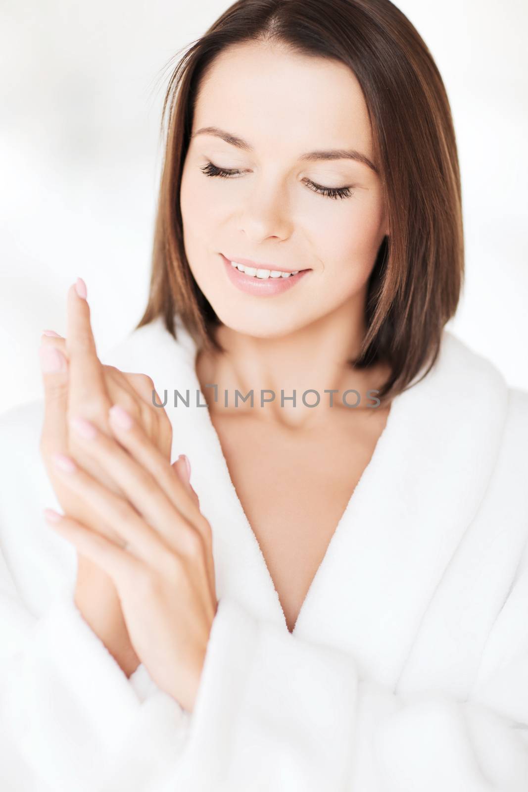 beauty, spa and people concept - beautiful woman in bathrobe