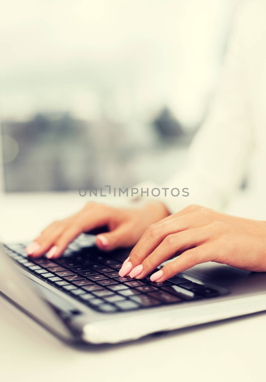 businesswoman using her laptop computer by dolgachov