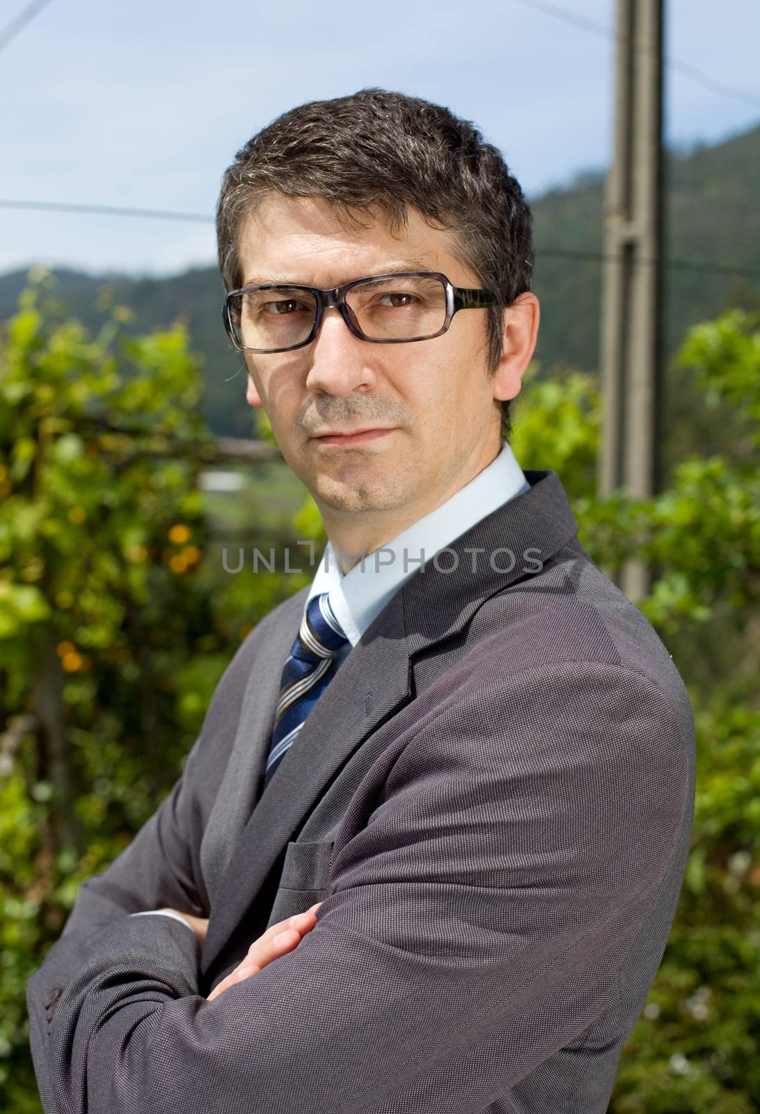 handsome businessman with glasses outdoors