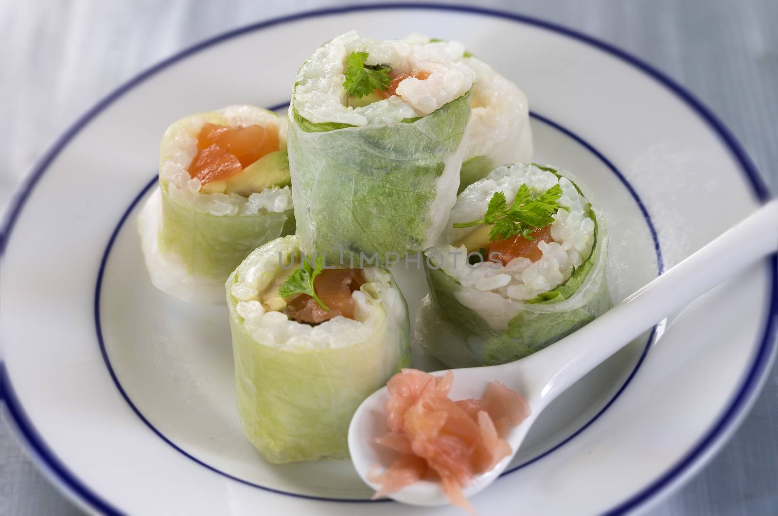 Delicious sushi rolls on white plate with chopsticks anwasabi