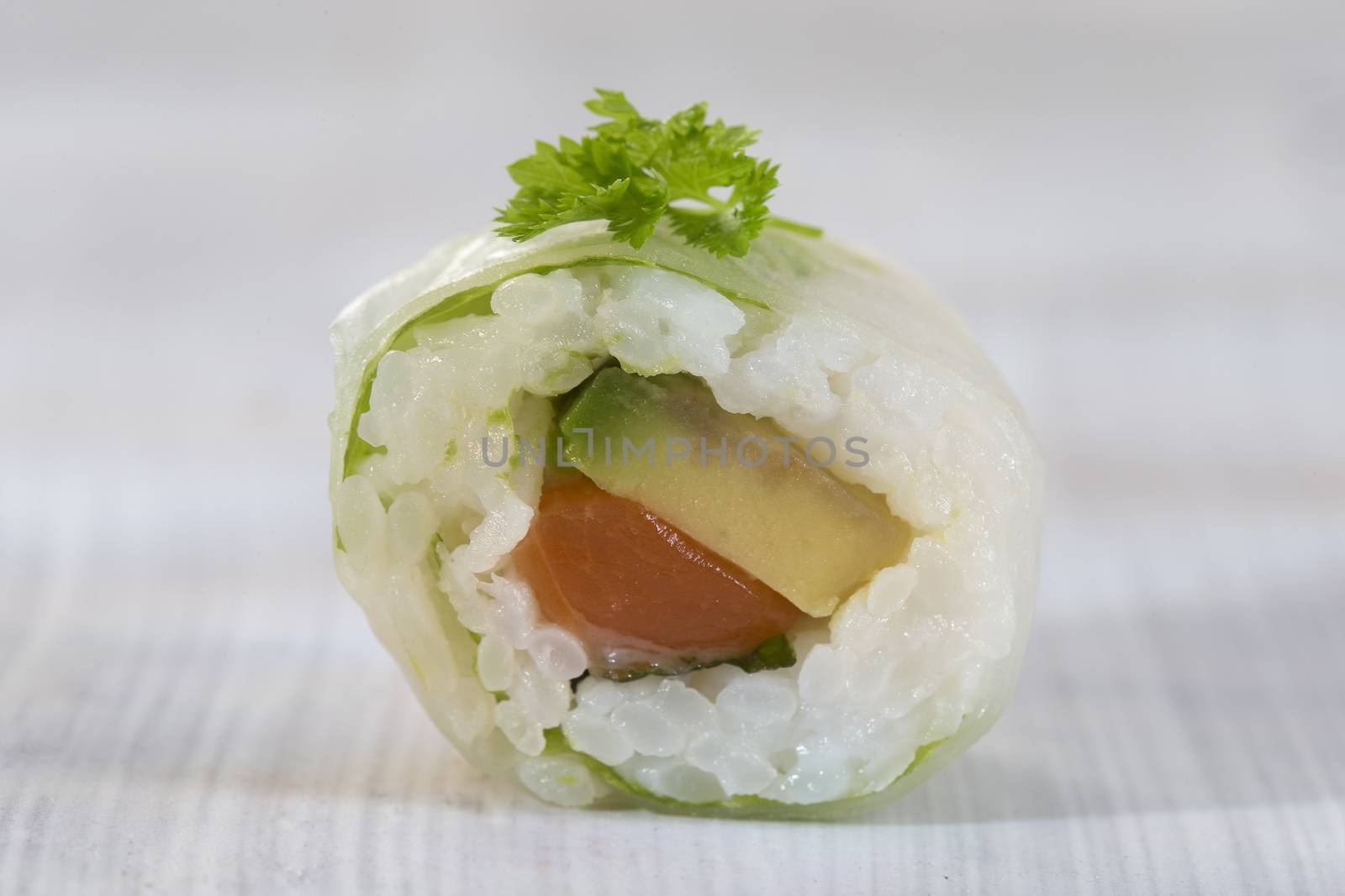 Delicious sushi rolls on white plate with chopsticks and wasabi