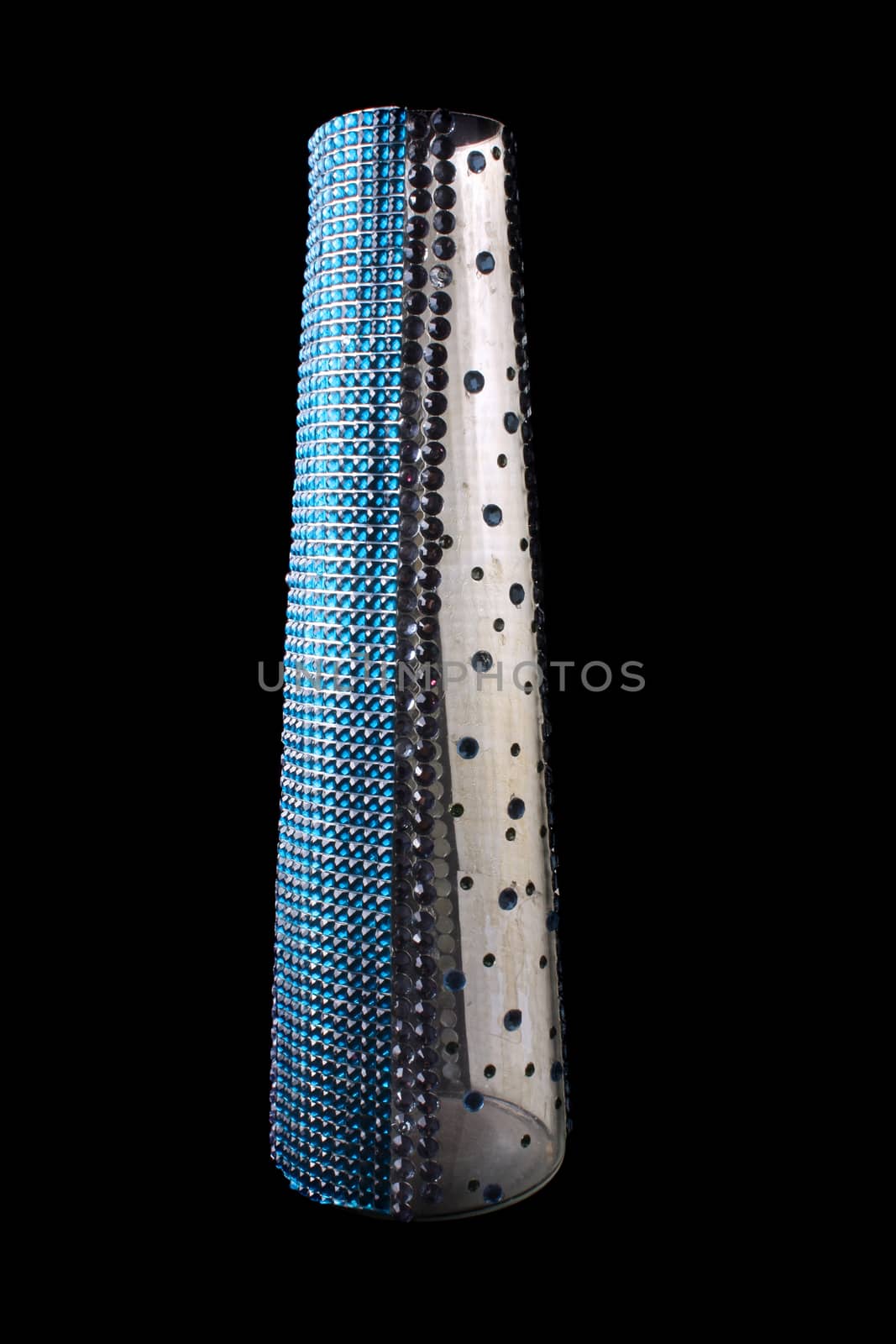 An ethnic flower vase with a beautiful design of blue and silver glass beads, on black background.