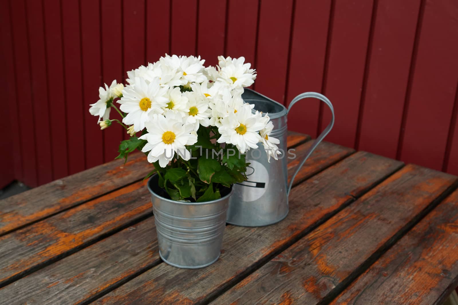 Beautiful still life basket of flowers on a rustic wooden table                               