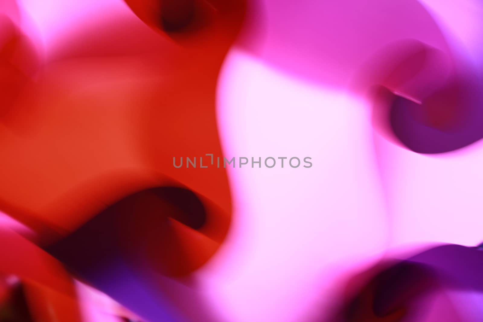 A background with an abstract design of swirling patterns in pink and red colors.
