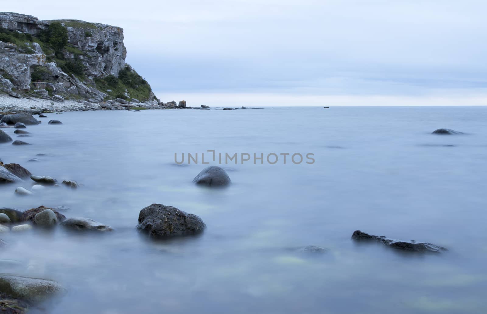 Calm Ocean with Rocks by Sea Stacks at Gotland, Sweden.