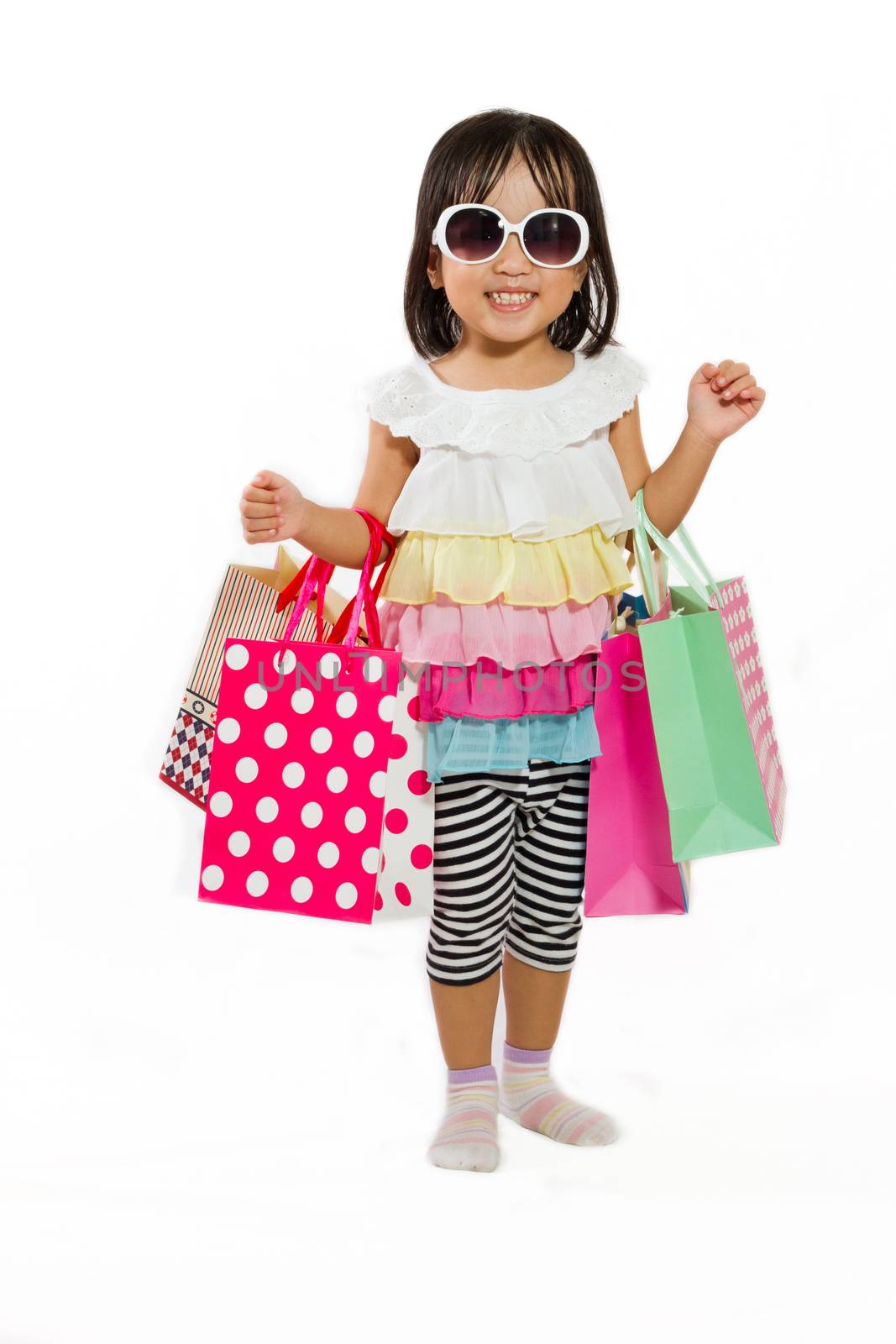 Asian Chinese little girl with shopping bag in white isolated background.