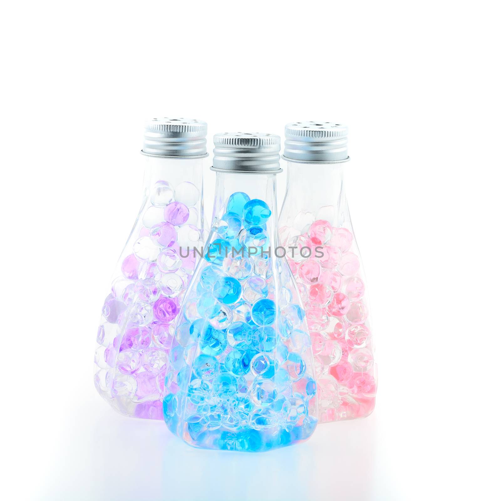 Three colorful bottles with beautiful gelatin inside, isolated on white background