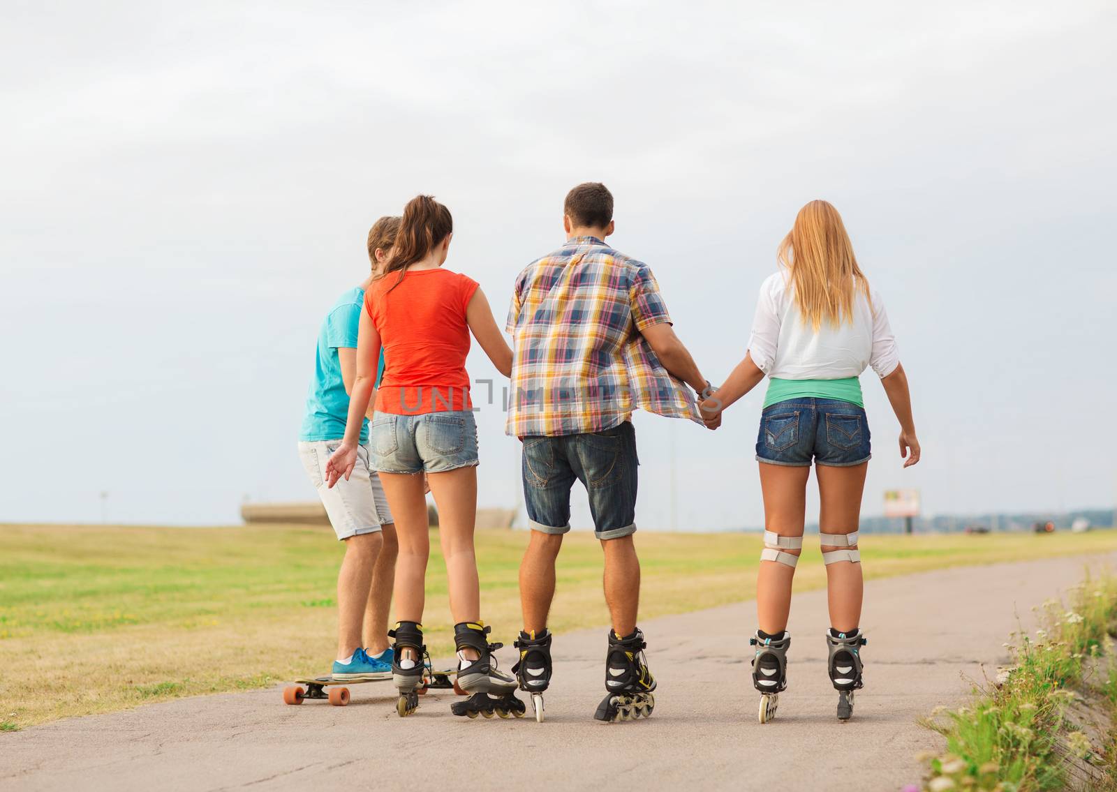 group of teenagers with roller-skates by dolgachov