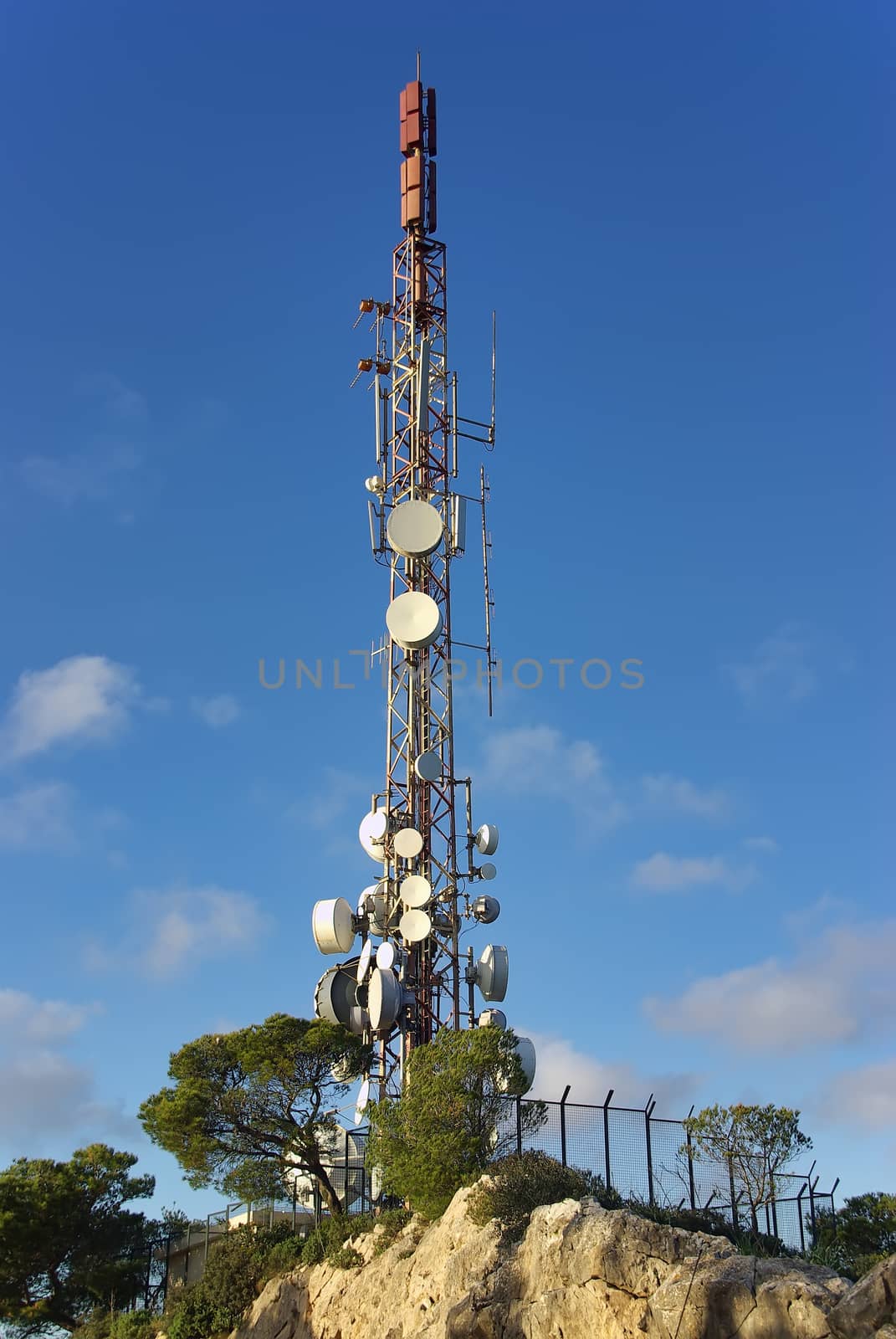 Communications tower on a mountain with a lot of antennas installed