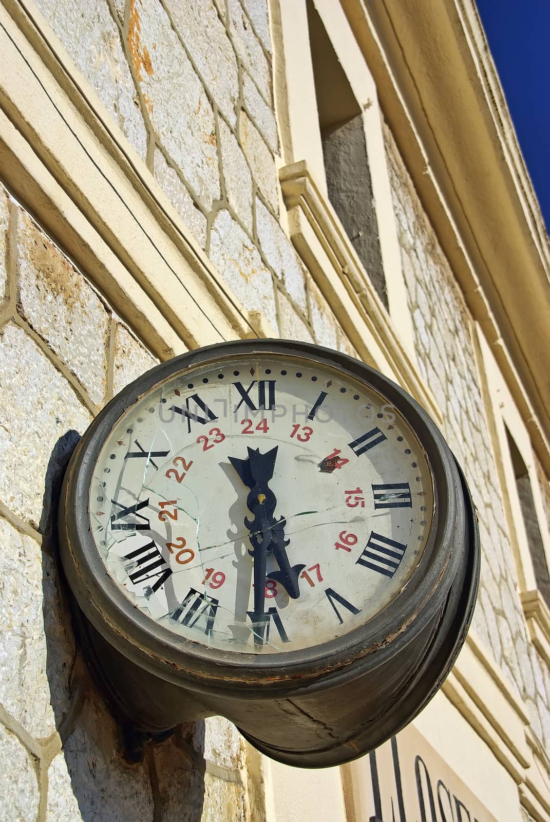 Clock with the glass broken on a rail station