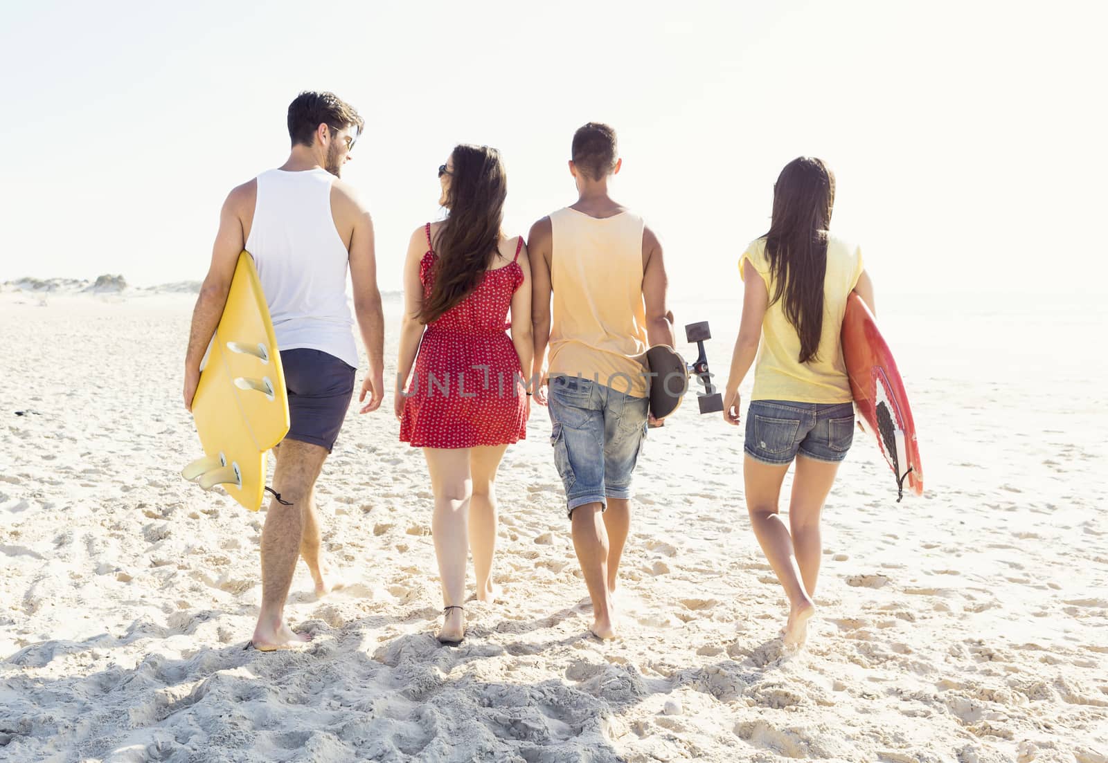 Group of friends walking together at the beach