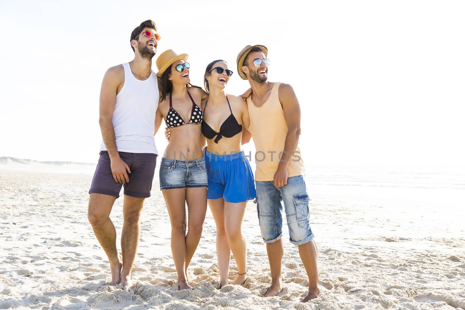 Group of friends having fun at the beach