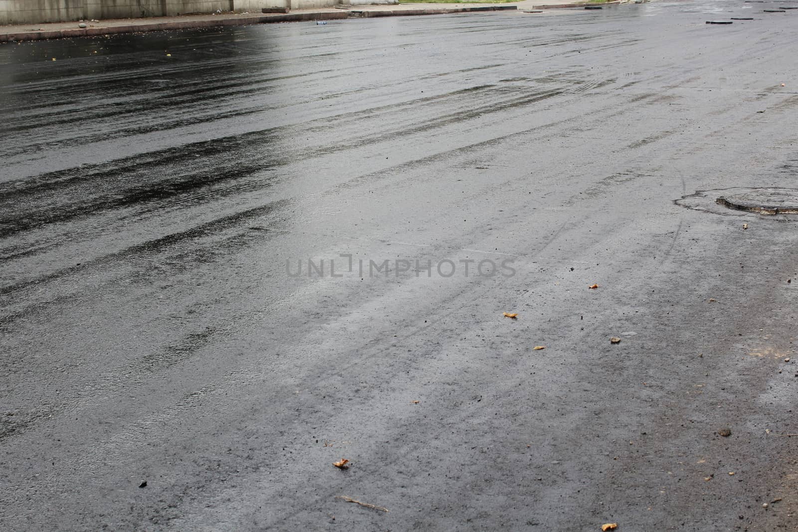 Freshly laid black tar asphalt pavement - a new road surface made of bitumen.