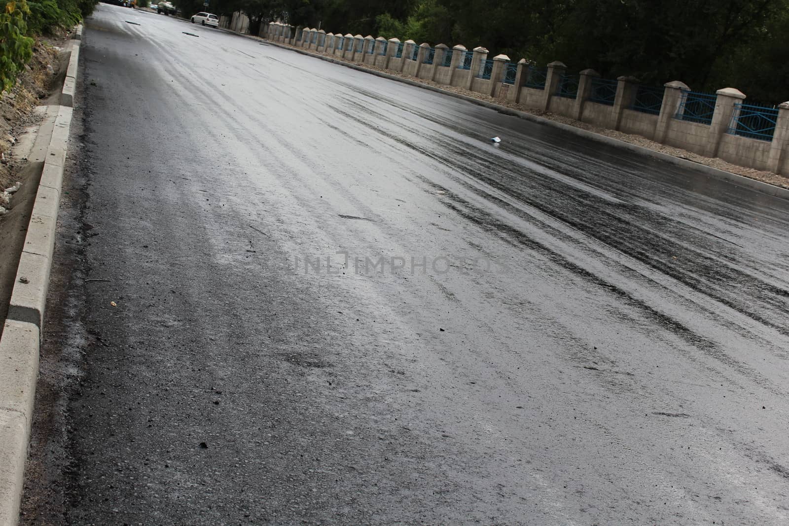 Freshly laid black tar asphalt pavement - a new road surface made of bitumen.