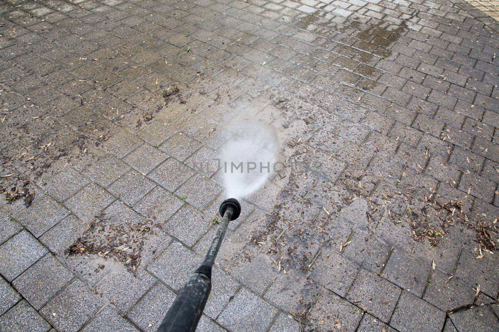 Outdoor floor cleaning with high pressure water jet