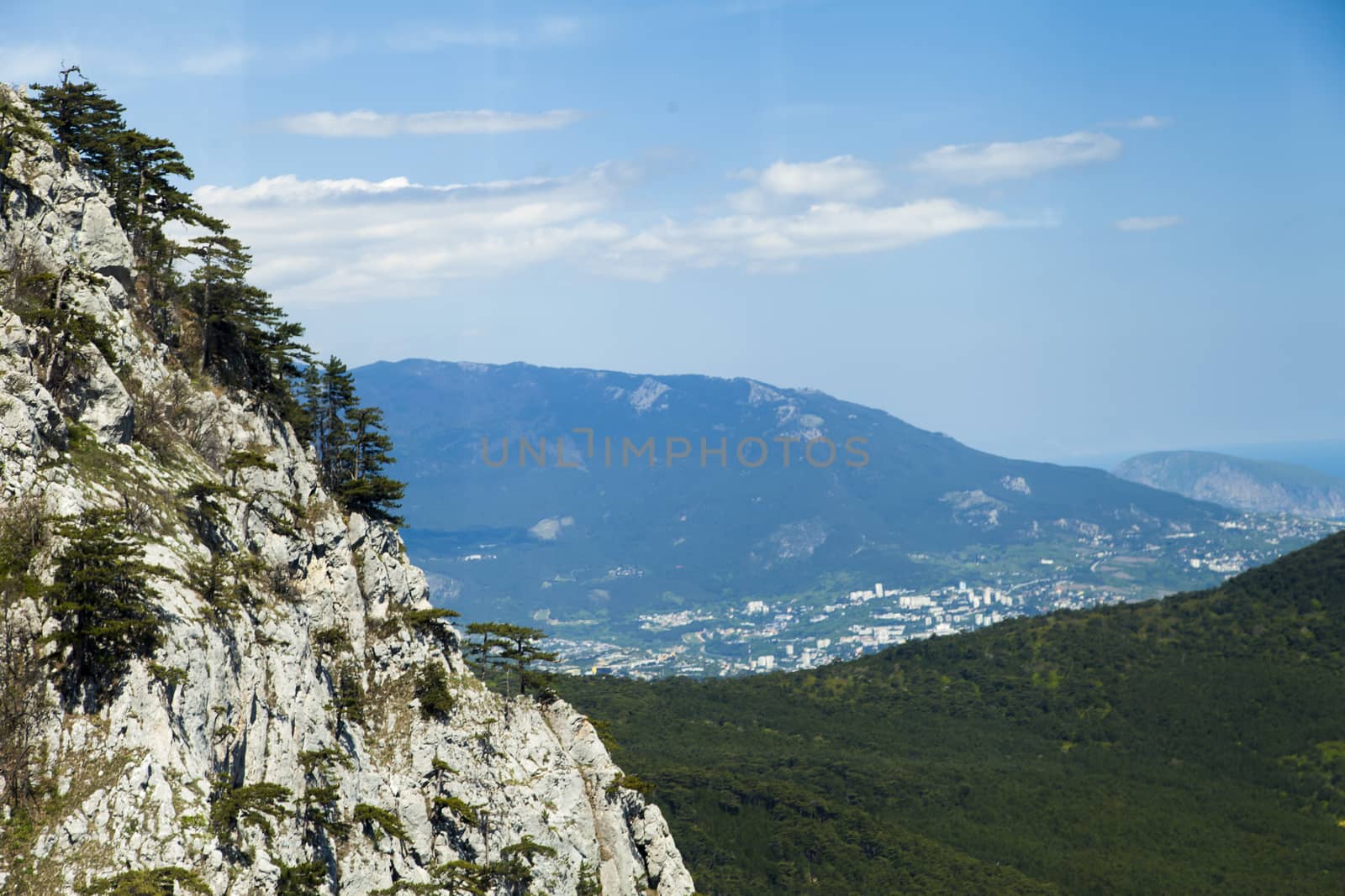 Mountains by the sea in beams of a bright sun