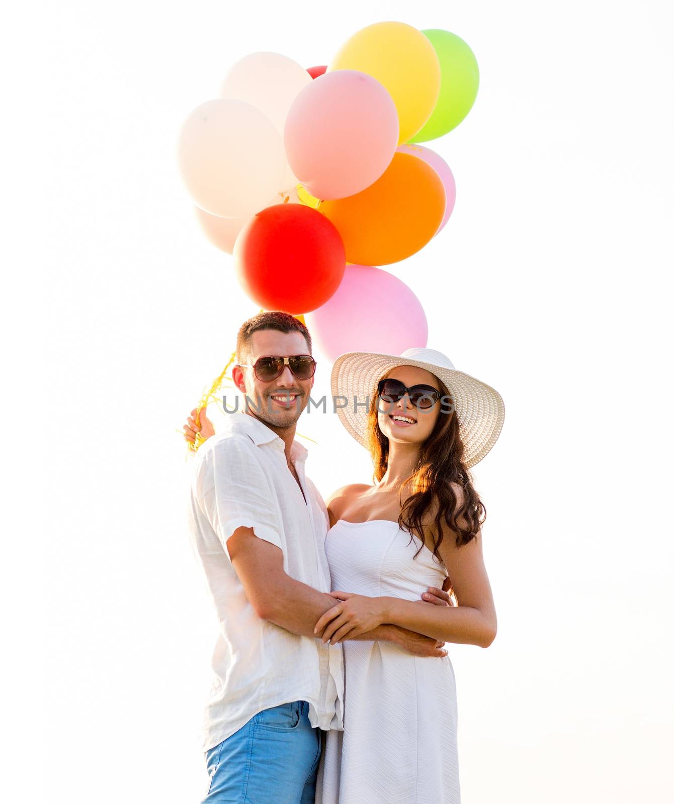 smiling couple with air balloons outdoors by dolgachov