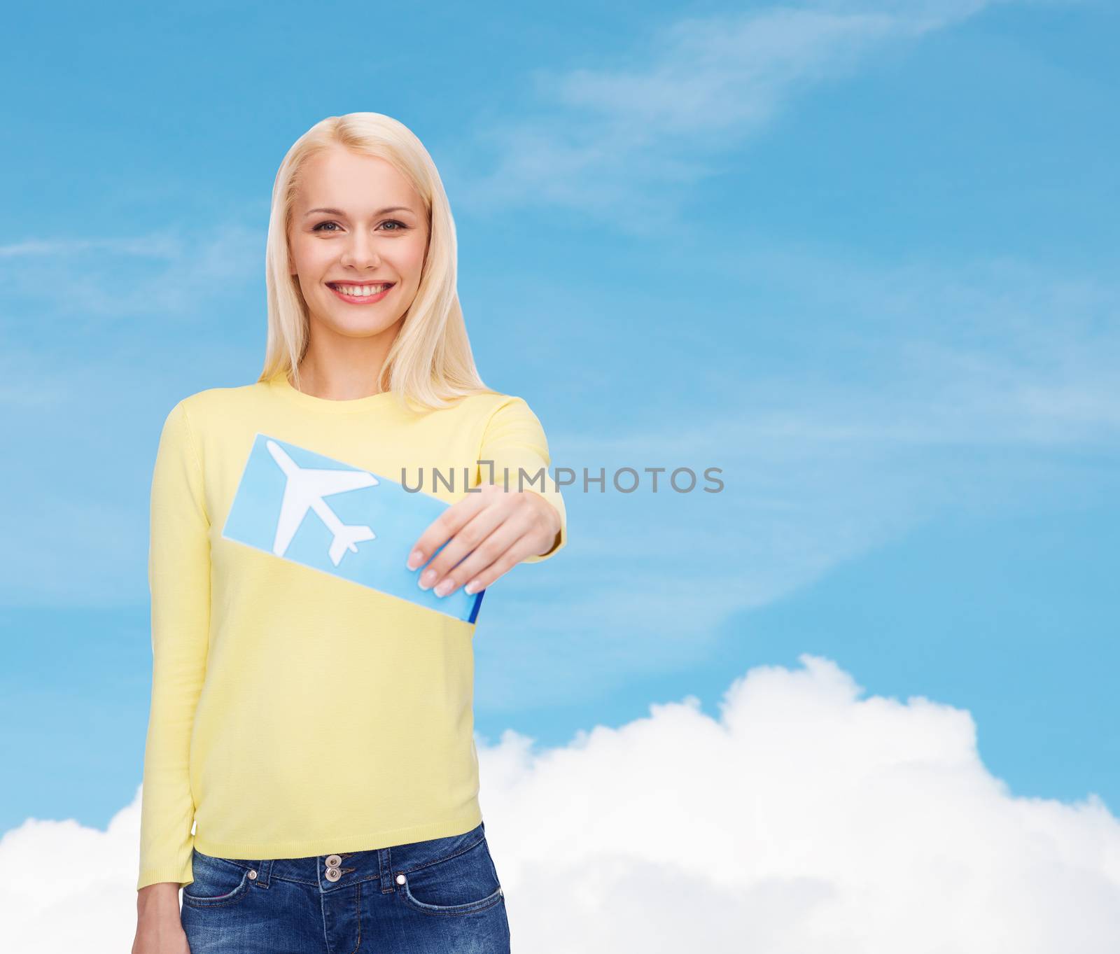 smiling young woman with airplane ticket by dolgachov