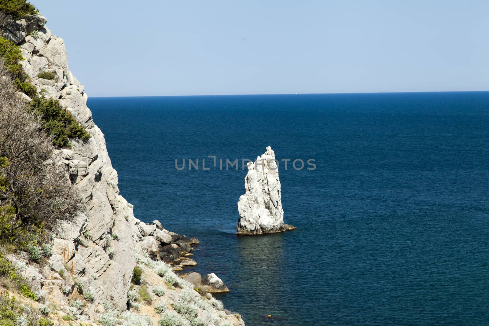 Mountains by the sea in beams of a bright sun