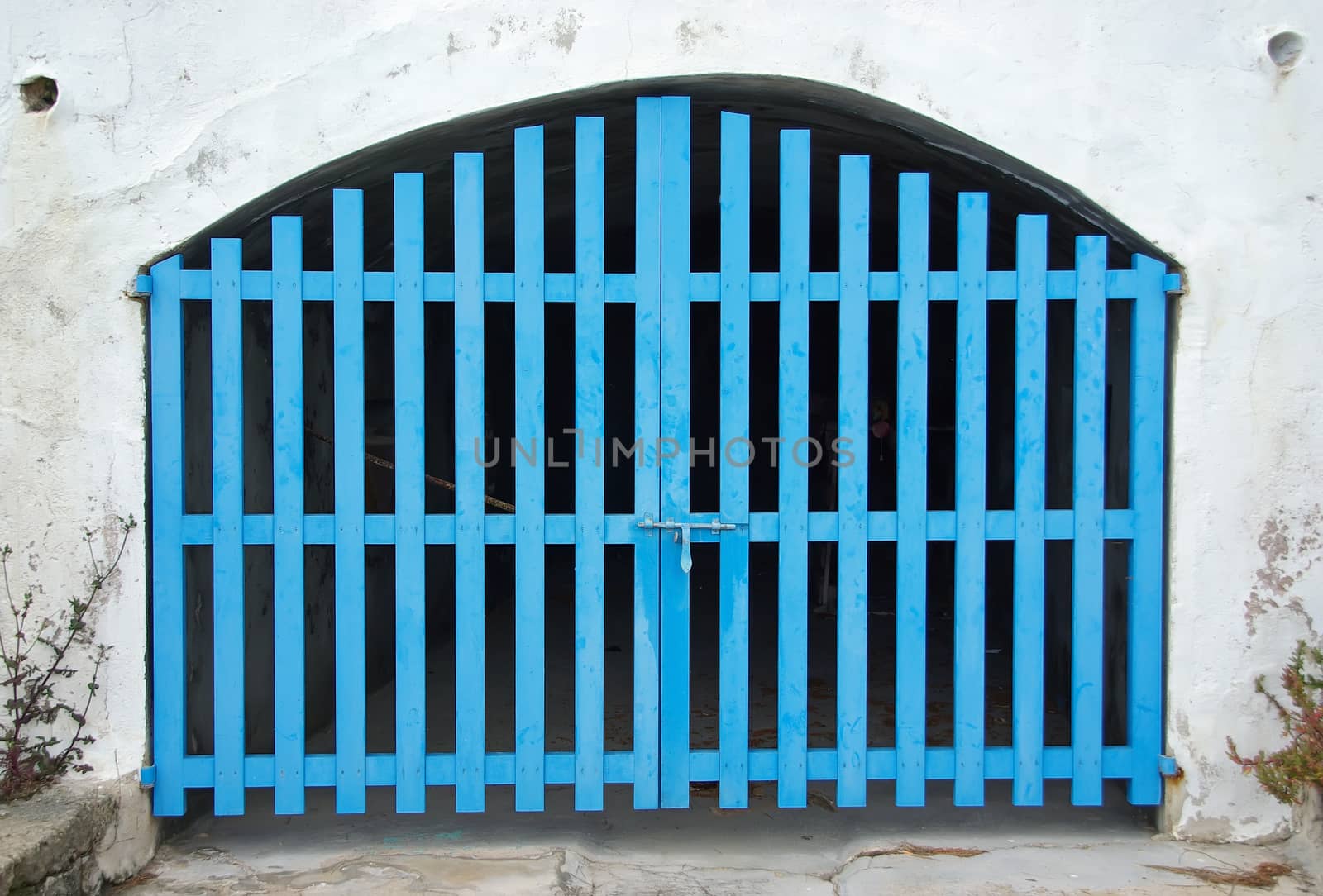 Old Cyan Wooden Door of a boat shelter in the Mediterranean Sea (Majorca)
